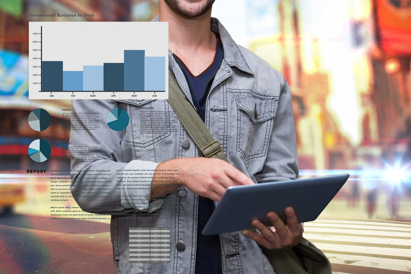 A close-up of a professional in a grey jacket using a digital tablet outdoors on a city street, overlaid with business metrics, bar graphs showing investment returns, data charts, and text blocks representing lead generation analytics.