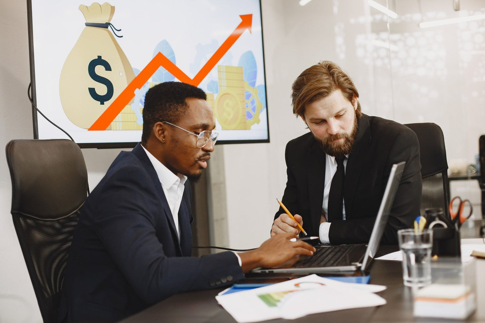 A professional holding a tablet displaying business growth metrics, representing an MCA broker using high-quality cash advance leads from Meridian Leads to scale their operations